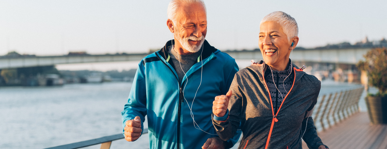 A couple jogging in functional outdoor jackets – breathable, lightweight, and weather-resistant activewear